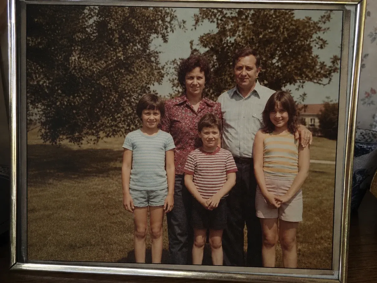 Same reprinted old photo after AI removed the glare and restored the faces