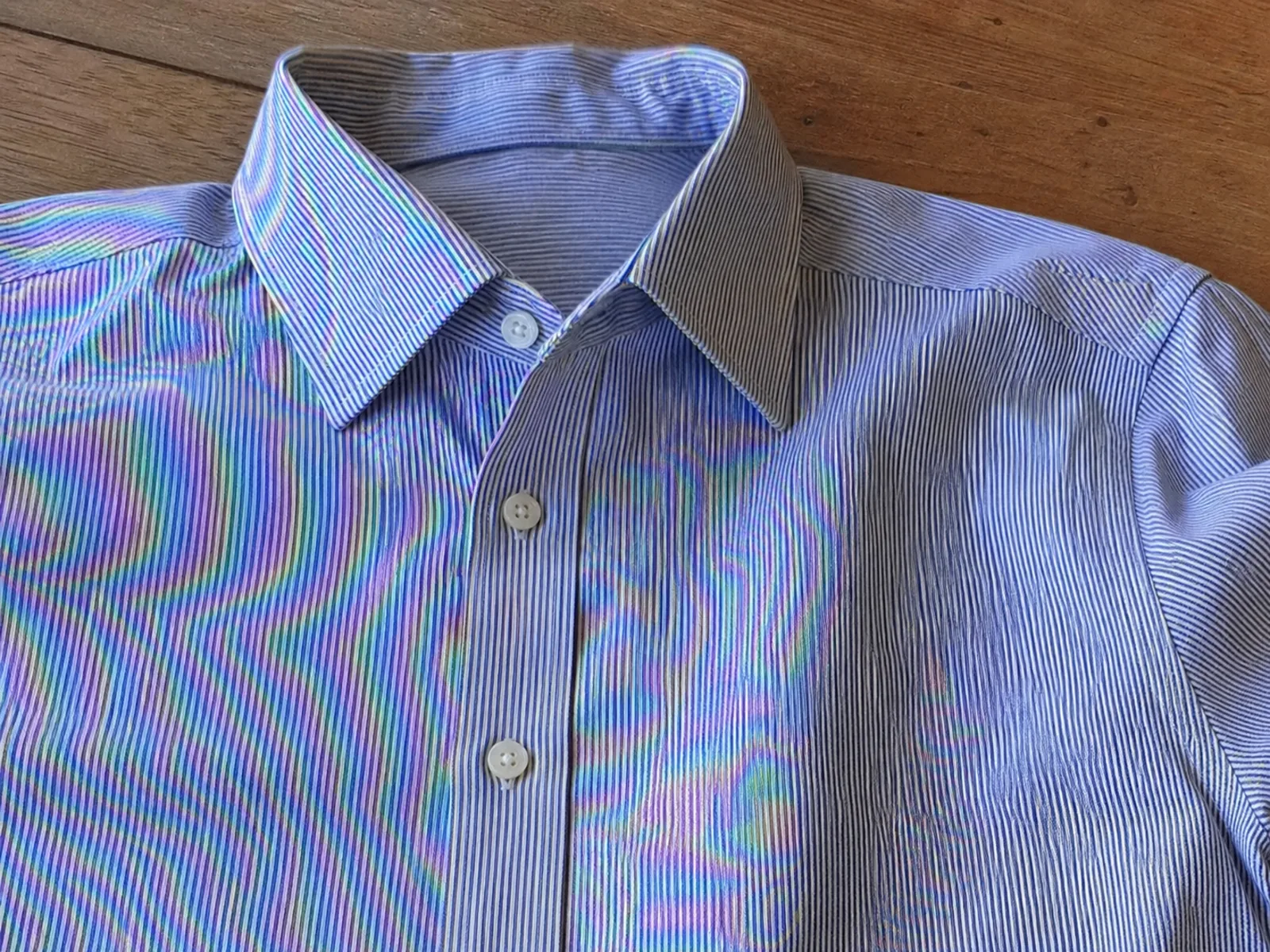 Phone photo of striped fabric showing moire shimmer before cleanup